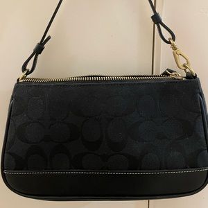 Vintage small signature Coach shoulder bag in black.